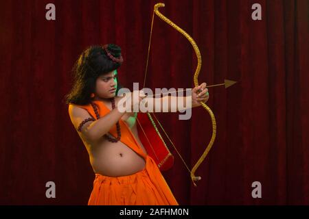 Lord Rama shooting an arrow with his bow. Gouache painting on mica by ...