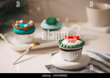 Seasonal festive Christmas mini dessert cupcakes in traditional decorative symbols elements Stock Photo