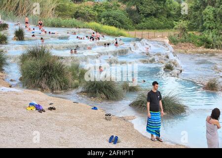 SATURNIA, ITALY - MAY 3, 2015: People visit natural hot springs in Saturnia, Italy. Thermal springs of Saturnia are a natural attraction of Southern T Stock Photo