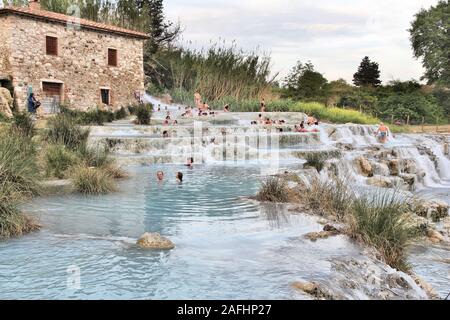 SATURNIA, ITALY - MAY 3, 2015: People visit natural hot springs in Saturnia, Italy. Thermal springs of Saturnia are a natural attraction of Southern T Stock Photo