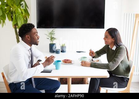 Business Couple At Home Eating Breakfast Before Leaving For Work Stock Photo