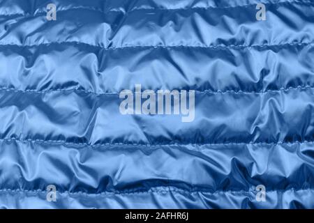 Holographic blue color wrinkled textile. Psychedelic or holographic background image. Stock Photo