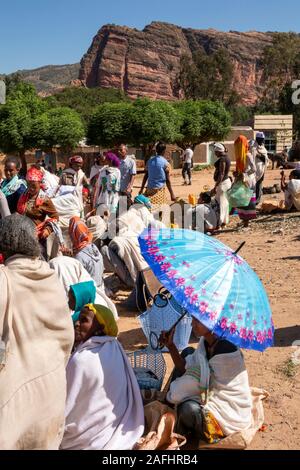 Ethiopia, Tigray, Wukro, Abraha Atsbeha village, weekly market, women traders, one sheltering from sun under umbrella Stock Photo