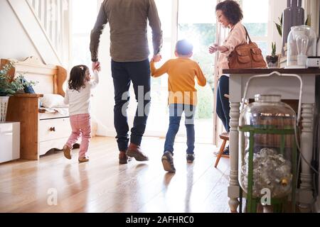 Rear View Of Family Leaving Home On Trip Out With Excited Children Stock Photo