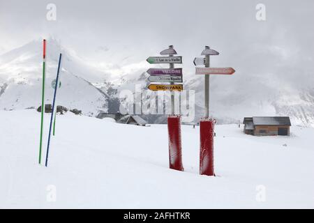 VALLOIRE, FRANCE - MARCH 27, 2015: Snow covered route signs in Galibier-Thabor station in France. The station is located in Valmeinier and Valloire an Stock Photo