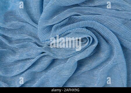 Background of corrugated silk classic blue color twisted fabric. Abstract background, empty template. Top view Stock Photo
