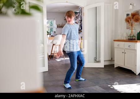 Young Downs Syndrome Man Having Fun Dancing At Home
