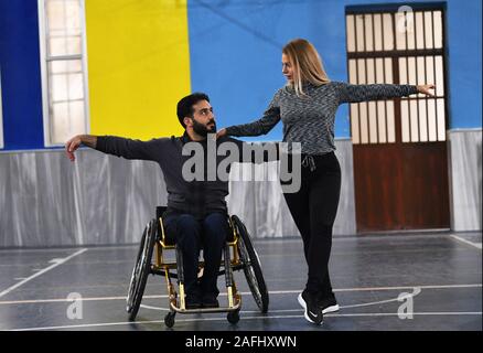 Damascus, Syria. 12th Dec, 2019. A Syrian man on wheelchair performs ballroom dances during a training course in Damascus, Syria, on Dec. 12, 2019. In a rehabilitation center for disabled people in Damascus, a handful of people on wheelchairs took part in a five-day dancing course that was organized by the United Nations Development Program (UNDP), which is the first wheelchair dancing course in the country. TO GO WITH 'Feature: Wheelchair dancers in Damascus challenge stereotype of disability' Credit: Ammar Safarjalani/Xinhua/Alamy Live News Stock Photo