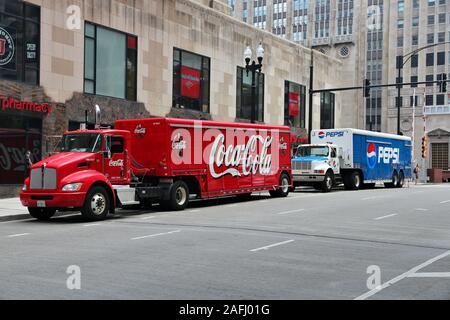 CHICAGO, USA - JUNE 27, 2013: Coca-Cola and Pepsi trucks in Chicago. Coca-Cola Company and PepsiCo have long standing rivalry in soft drink market.