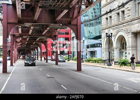 CHICAGO, USA - JUNE 28, 2013: Cars drive below elevated train tracks in Chicago. Chicago is the 3rd most populous US city with 2.7 million residents ( Stock Photo