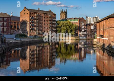 LEEDS, UNITED KINGDOM - AUGUST 13: View of old riverside city buildings along the River Aire near the famous Leeds Bridge on August 13, 2019 in Leeds Stock Photo