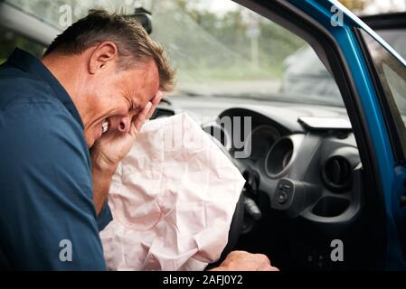 Male Motorist Injured In Car Crash With Airbag Deployed Stock Photo
