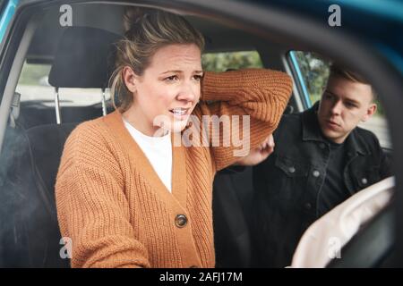 Couple Involved In Car Crash With Female Driver Suffering With Whiplash Injury Stock Photo