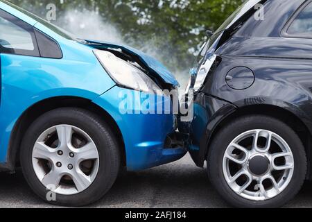 Close Up Of Two Cars Damaged In Road Traffic Accident Stock Photo
