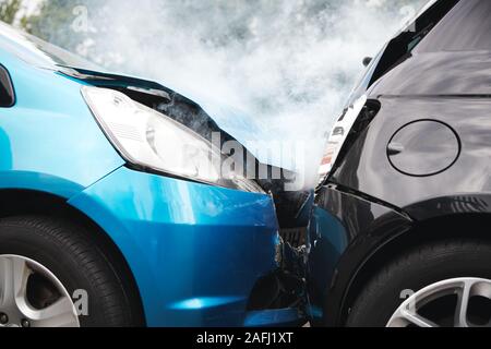 Close Up Of Two Cars Damaged In Road Traffic Accident Stock Photo