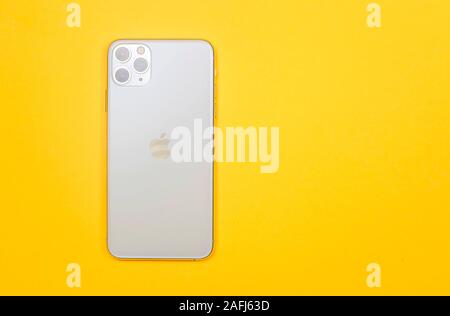 Kiev, Ukraine - November 13, 2019: new white smartphone Apple Computers iPhone 11 Pro and 11 Pro Max smartphone with three cameras or lenses on a yell Stock Photo