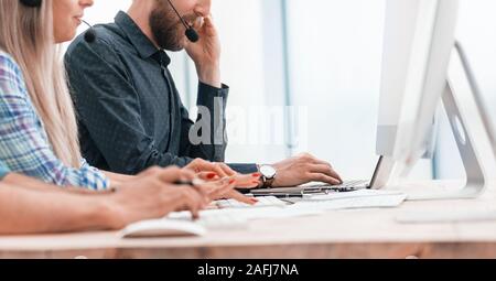 call center operators use computers to work with clients. Stock Photo