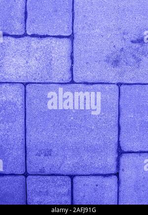 Vertical background with geometric pattern of highly detailed street pavement made of various square blocks. Textured rough surface toned in electric Stock Photo