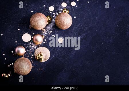 Christmas golden toy, glitter balls on dark blue background. Copy space Stock Photo