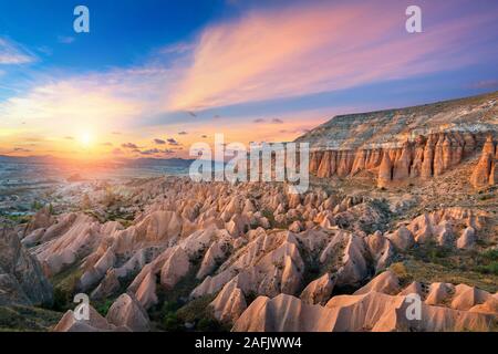 Beautiful mountains and Red valley  at sunset in Goreme, Cappadocia in Turkey. Stock Photo