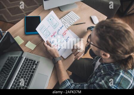 Man in checkered shirt working in the office Stock Photo