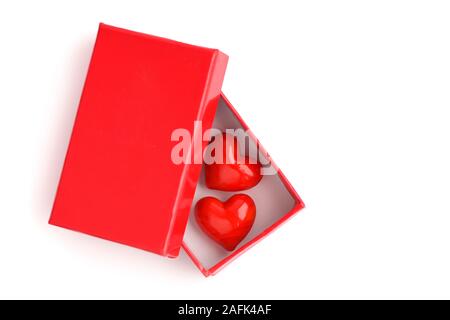 Two hearts in a red gift box on a white background. The Valentine's Day Concept Stock Photo
