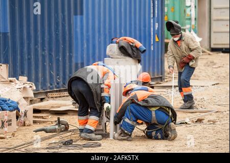 Workers on construction site of gas factory Stock Photo