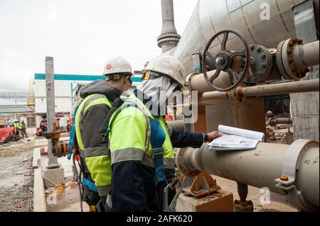 Worker on a construction site check documents Stock Photo
