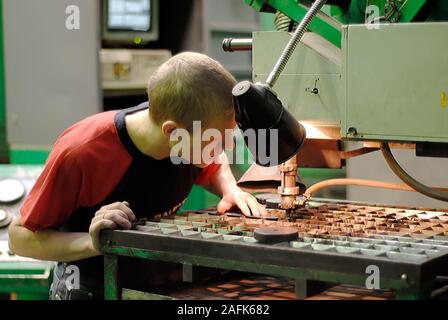 Milling-machine operator works at machine Stock Photo