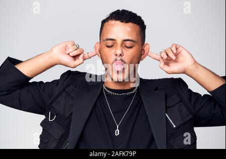 Head And Shoulders Studio Shot Of Man Pulling Faces And Smiling At Camera Stock Photo