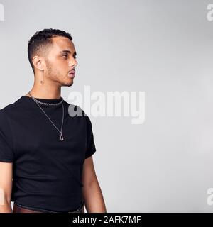 Thoughtful Young Man With Skin Pigmentation Disorder Looking Off Camera In Studio Stock Photo