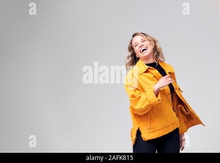 Studio Shot Of Young Woman Against White Background Having Fun Dancing Stock Photo