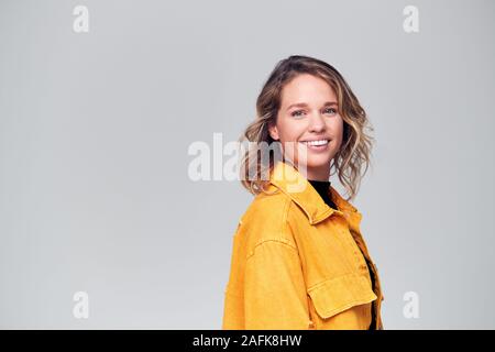 Offset Studio Portrait Of Positive Happy Young Woman Smiling Off Camera Stock Photo