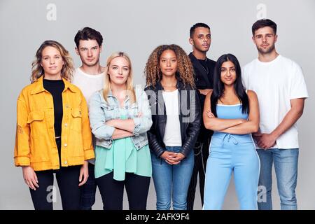 Group Studio Shot Of Young Multi-Cultural Friends Smiling And Laughing At Camera Stock Photo