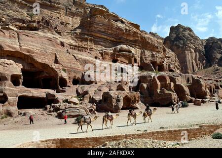 Petra, Jordan - March 06, 2019: Unidentified people and camels in UNESCO World heritage site of ancient Petra