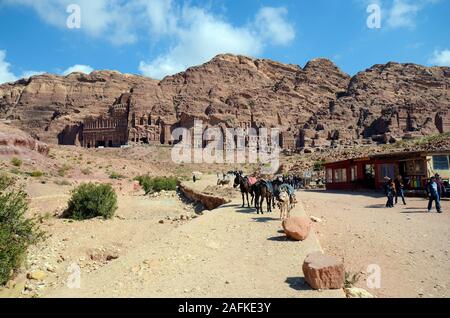 Petra, Jordan - March 06, 2019: Unidentified people, shops, horses and donkeys in UNESCO World heritage site of ancient Petra