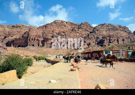 Petra, Jordan - March 06, 2019: Unidentified people, shops, horses and camels in UNESCO World heritage site of ancient Petra