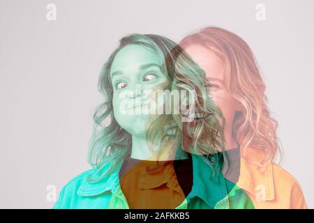 Composite Concept Image Showing Contrasting Emotions On Face Of Young Woman Using Social Media Stock Photo