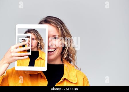 Composite Concept Image Showing Contrasting Emotions Of Woman Using Social Media With Digital Tablet Stock Photo