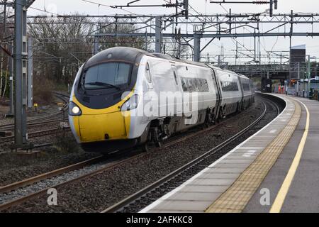 Avanti West Coast 9 car Pendolino 390013 rushes through Lichfield Trent Valley with 1F15 the 11:07 London Euston to Liverpool  on 16 December 2019 Stock Photo