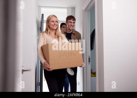 Group Of College Student Carrying Boxes Moving Into Accommodation Together Stock Photo