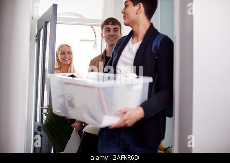 Group Of College Student Carrying Boxes Moving Into Accommodation Together Stock Photo