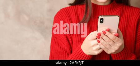 Beautiful woman using phone on brown background. Space for text Stock Photo