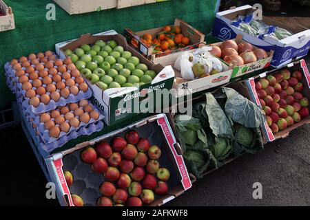 A selection of eggs, fresh fruit and vegetables on sale outside at a greengrocers, England, UK Stock Photo