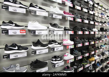 A display wall of mens trainers with prices at JD Sports shop, 2019 Stock Photo