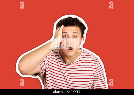 man with strong expression of fear, round eyes, open mouth and hands pressed to top of head, showing astonishment and shock. emotional guy isolated Ma Stock Photo