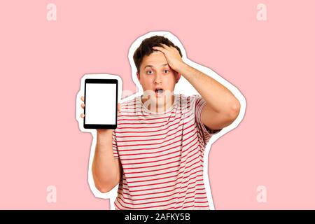 Young anxious holding his head with hands. Worried guy holding tablet blank screen. emotional guy isolated on white background Magazine collage style Stock Photo