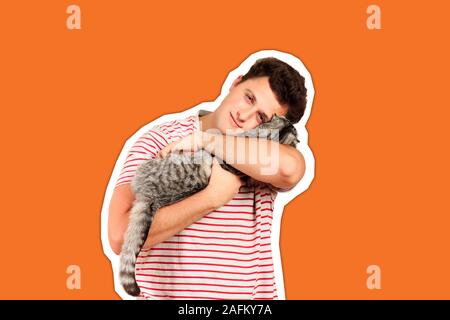 a guy holding a Scottish cat in his arms and feels caressing from him. emotional man isolated Magazine collage style with trendy color. Stock Photo