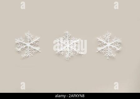White snowflakes on gray background. Winter holidays concept. New Year and Christmas decoration Stock Photo