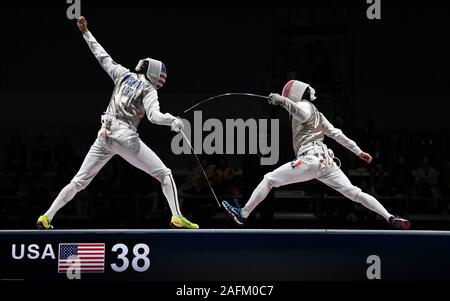 Chiba, Japan. 15th Dec, 2019. (L-R) ALEXANDER MASSIALAS of USA vs ERWANN LE PECHOUX of France during the final match of the Men's Foil Team competition at the Fencing World Cup 2019. France went on to win the Team Cup. Credit: Ramiro Agustin Vargas Tabares/ZUMA Wire/Alamy Live News Stock Photo